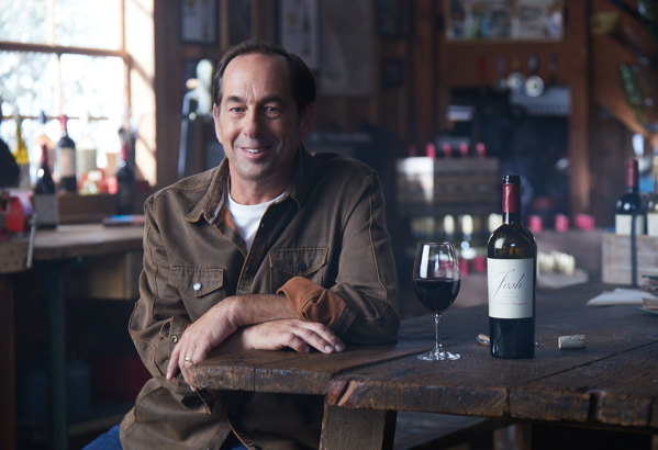 Founder Joseph Carr next to an open bottle of Josh Cellars wine