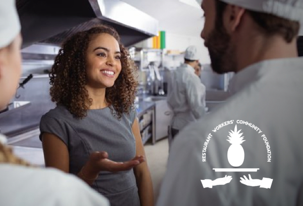 Chefs in a professional kitchen talking with a logo for Restaurant Workers' Community Foundation