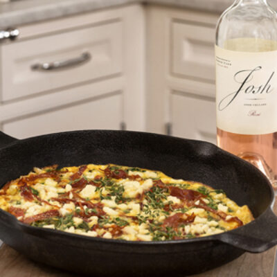 Picture of a Goat Cheese Frittata next to a bottle of Josh wines