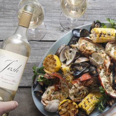 Grilled Lobster Tails next to a bottle of Josh wines