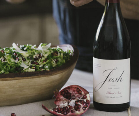 Pomegranate salad next to a bottle of Josh wines