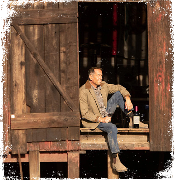Joseph Carr sitting in barn door